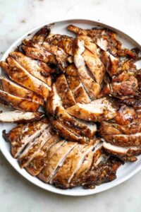 Top view of sliced chicken on a plate.