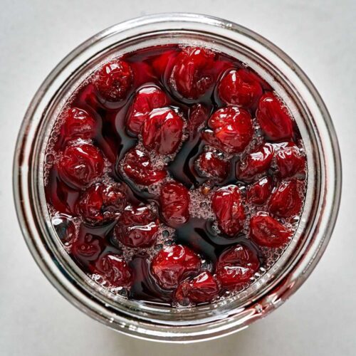 Top view of cooked sour cherries syrup.