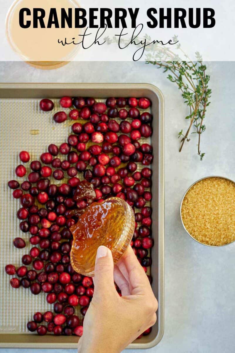 Pouring honey over cranberries on a baking sheet with title text.