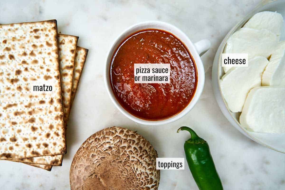 Matzo pieces, pizza sauce, and other ingredients with text labels.