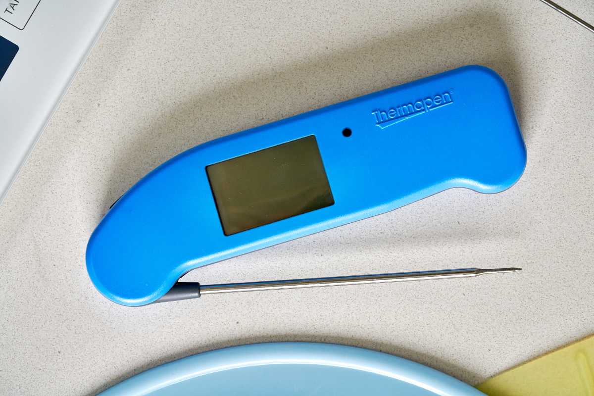 Blue kitchen thermometer on a countertop.