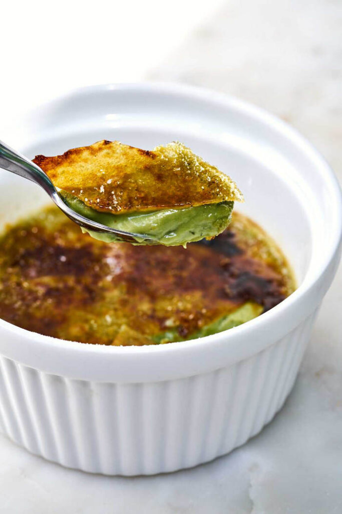 Spoon scooping out the perfect bite of matcha creme brulee.