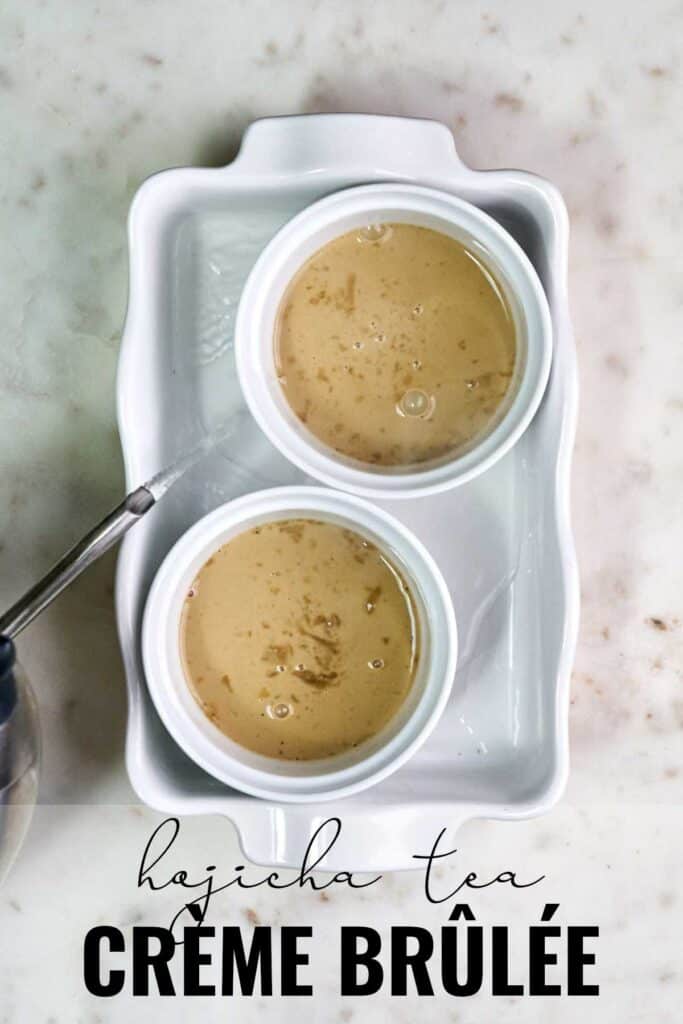 Pouring hot water into a roasting pan with two ramekins filled with creme brulee.