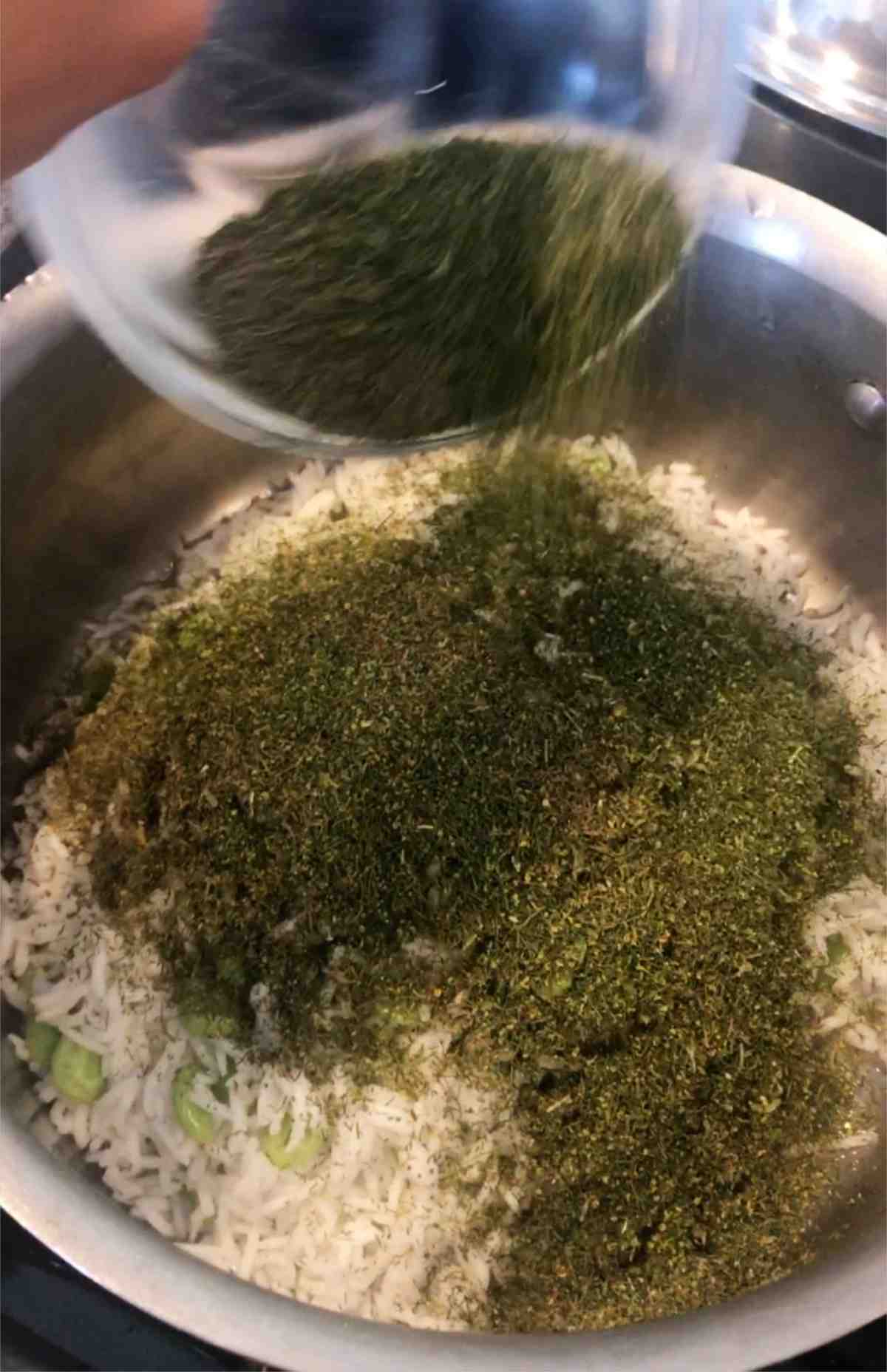 Dried herbs in a pot on top of rice.