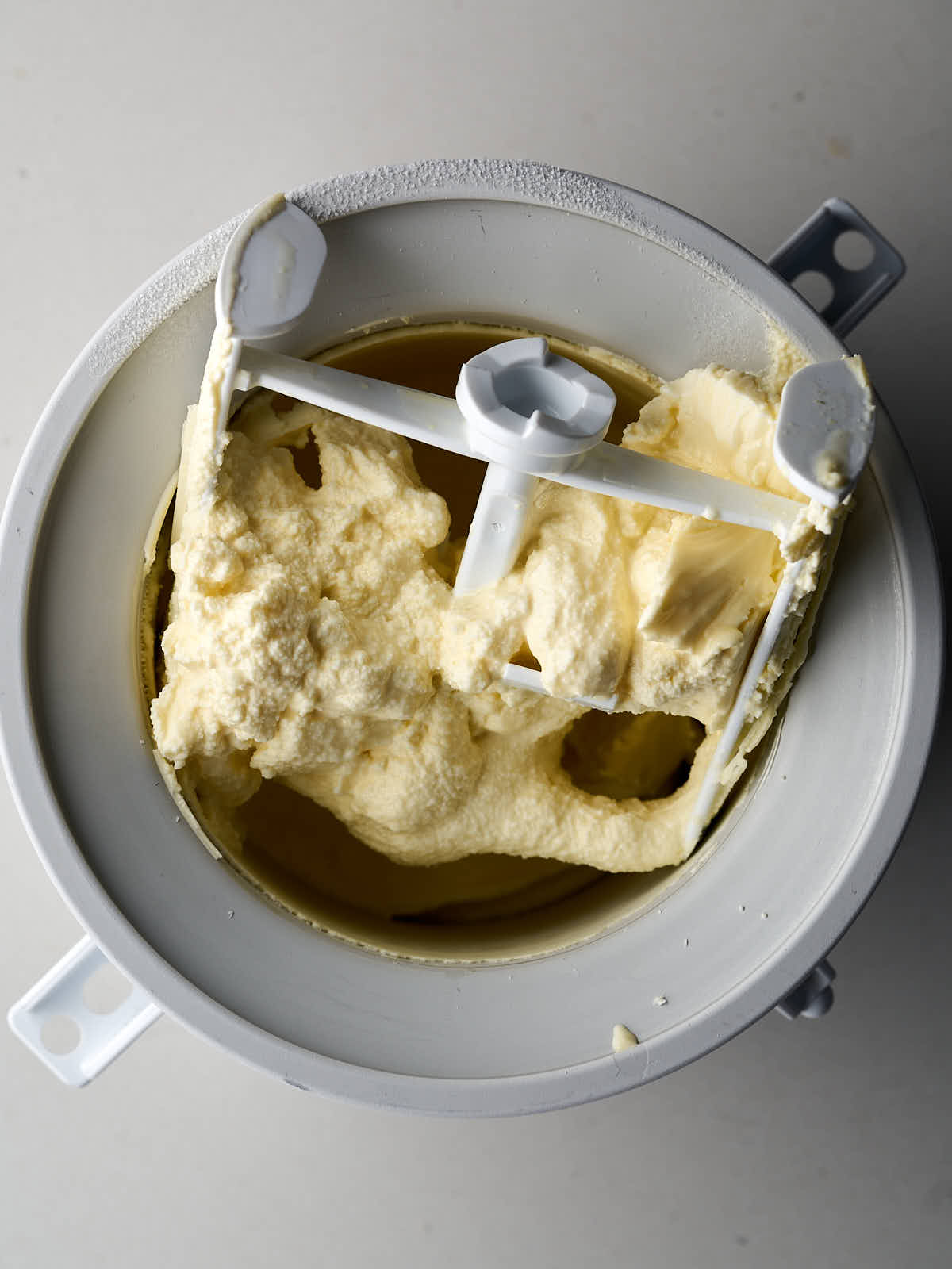 Light green stand mixer fitted with the ice cream attachment.