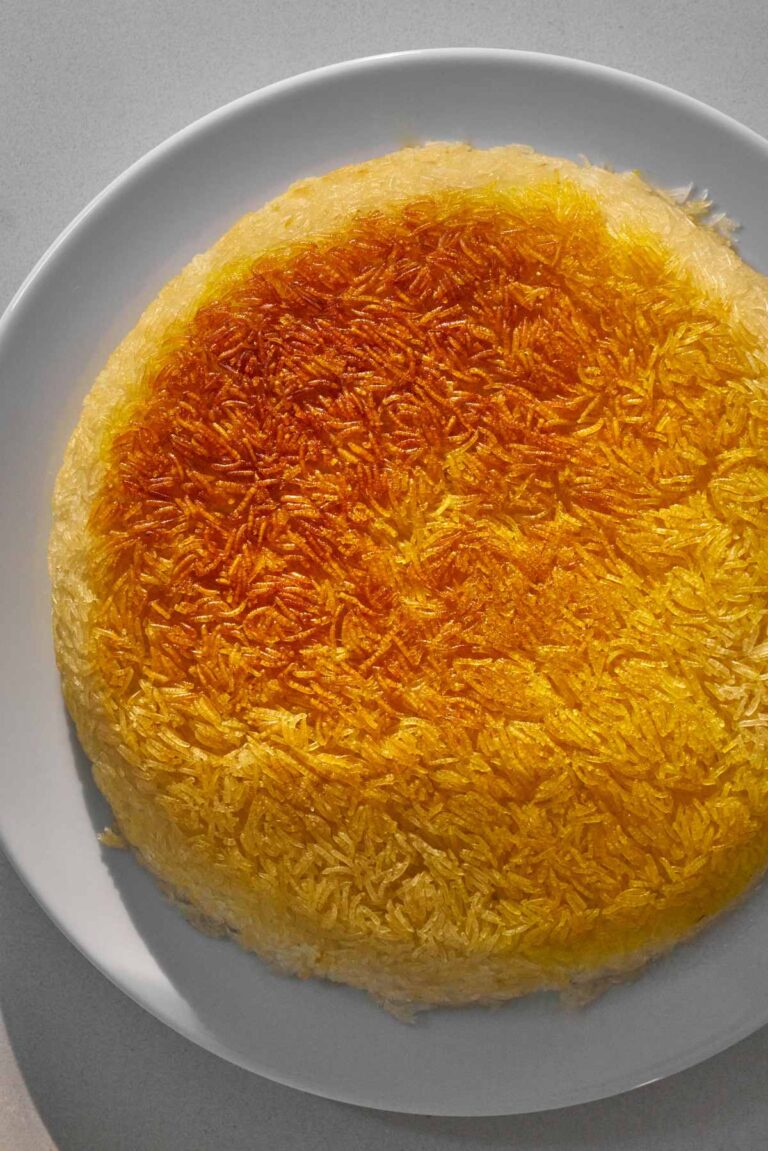 Crispy yellow rice tahdig on a white plate.