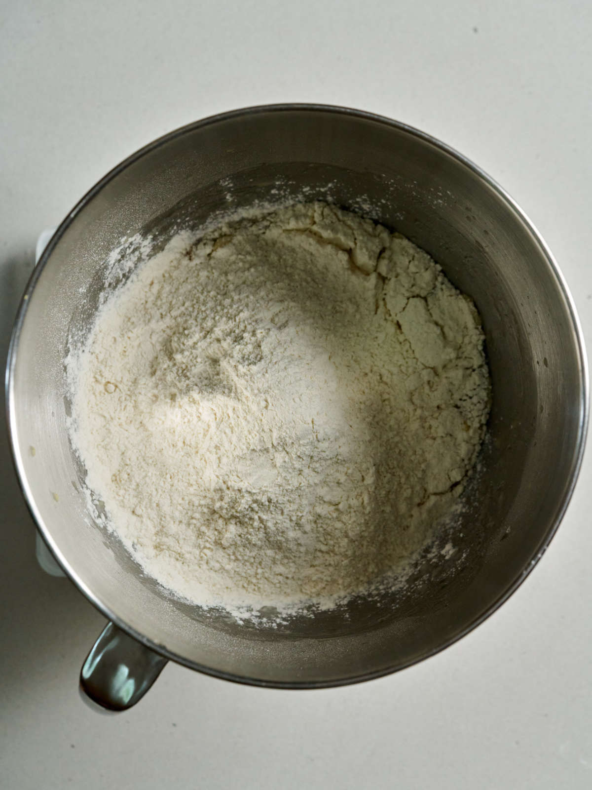 Flour in a metal stand mixer bowl.