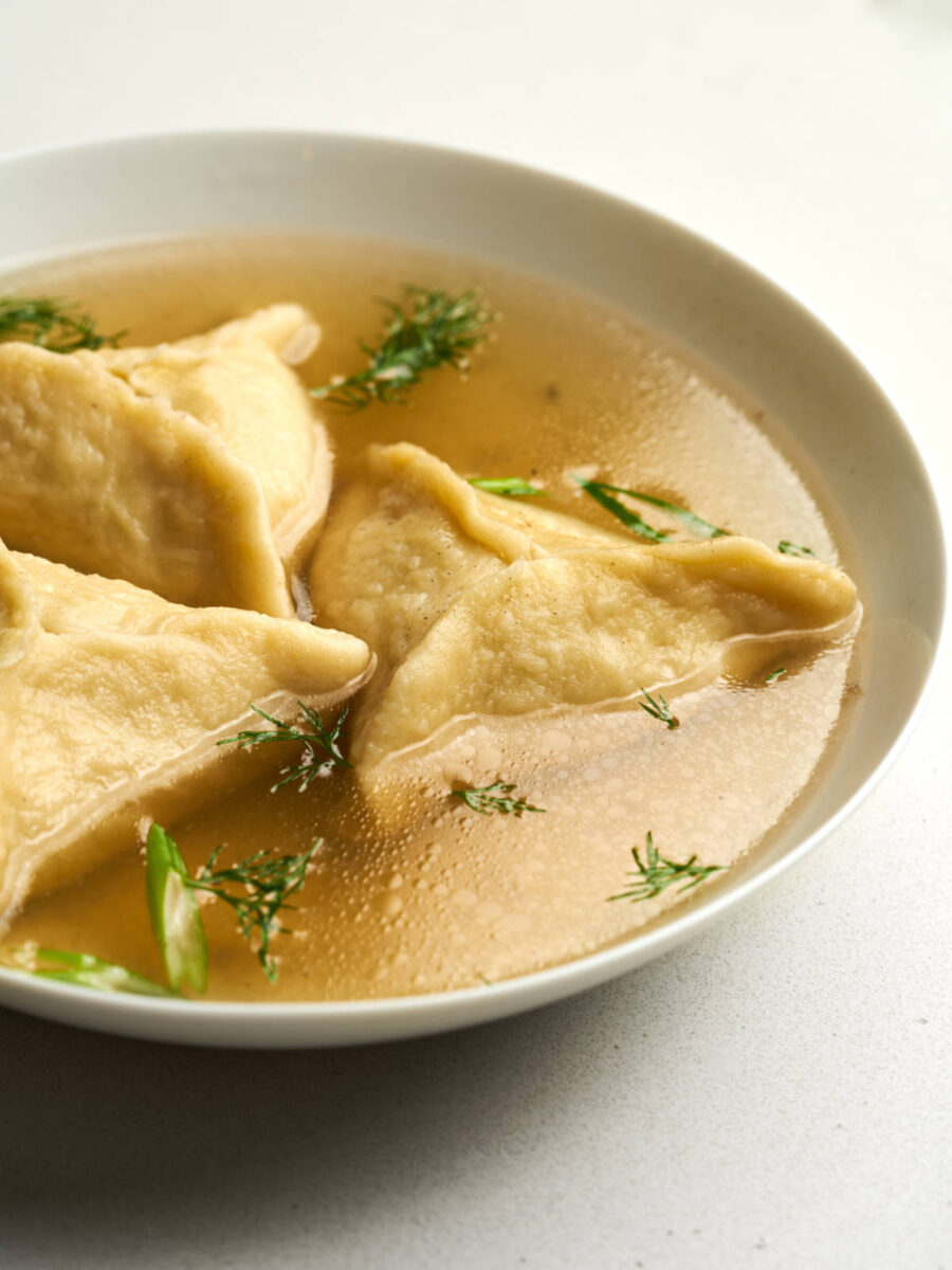 Triangular dumplings in chicken broth with fresh herbs.