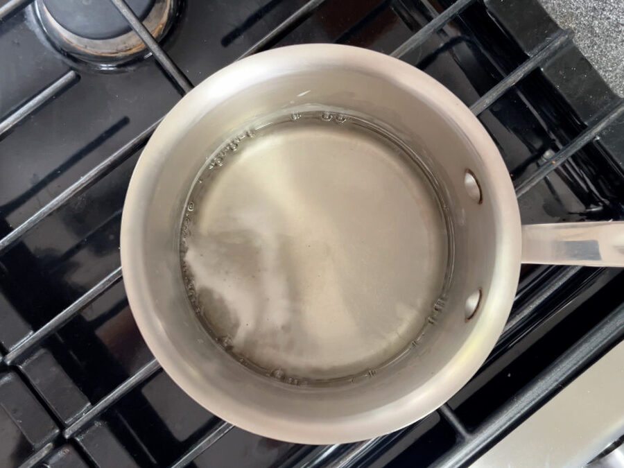 Water simmering in a pot on the stove.