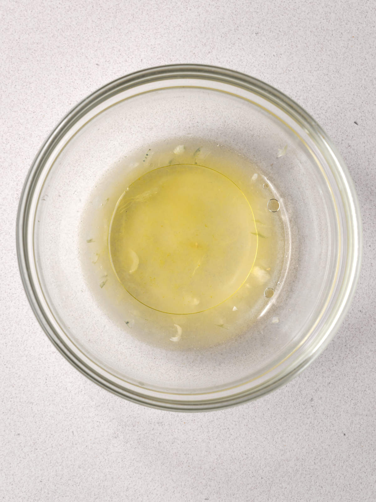 Yellow liquid in a small glass bowl.