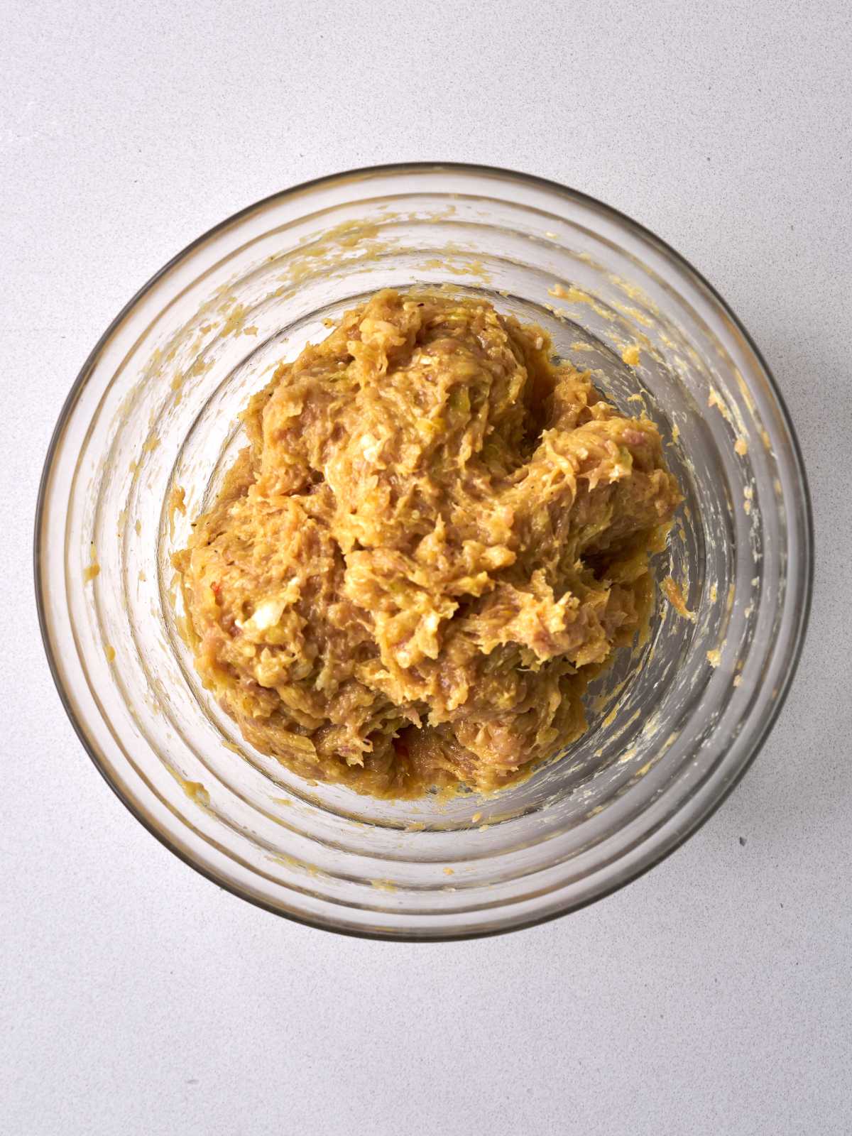 Ground chicken mixture in a glass bowl.