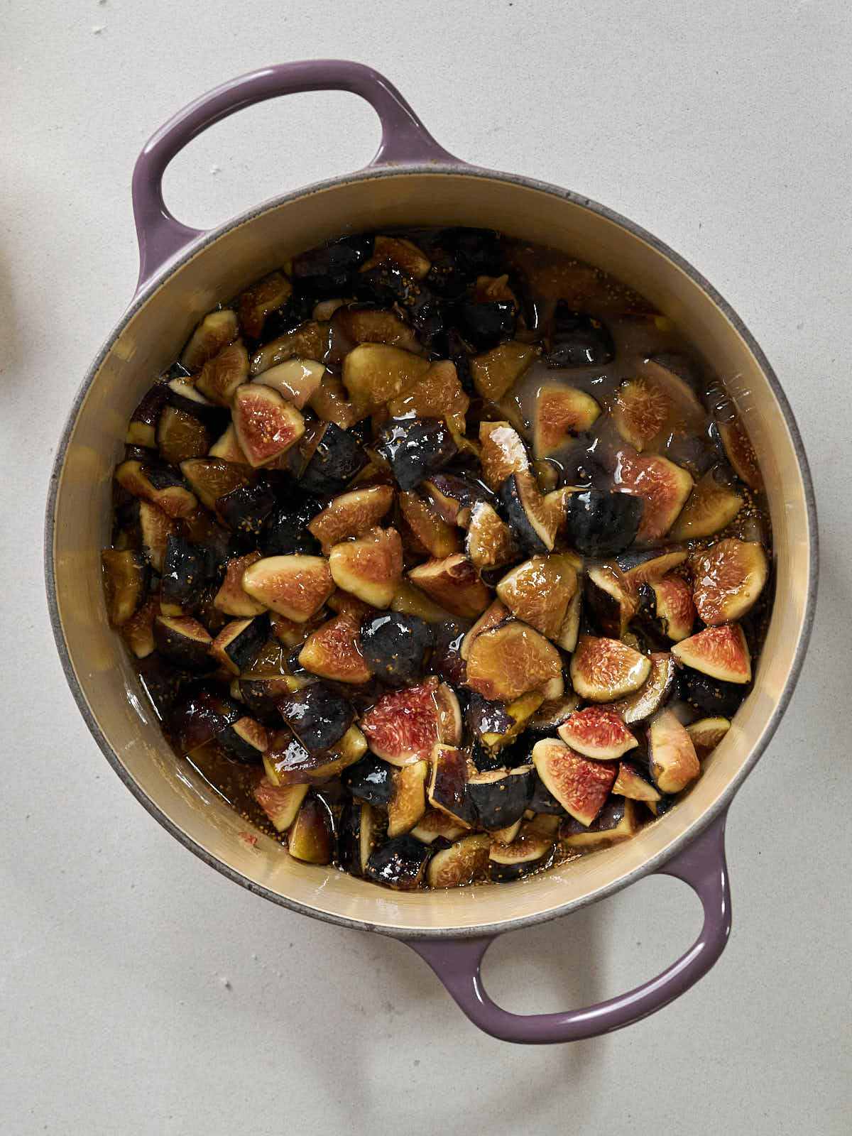 Chopped figs in a purple enameled cast iron pot.