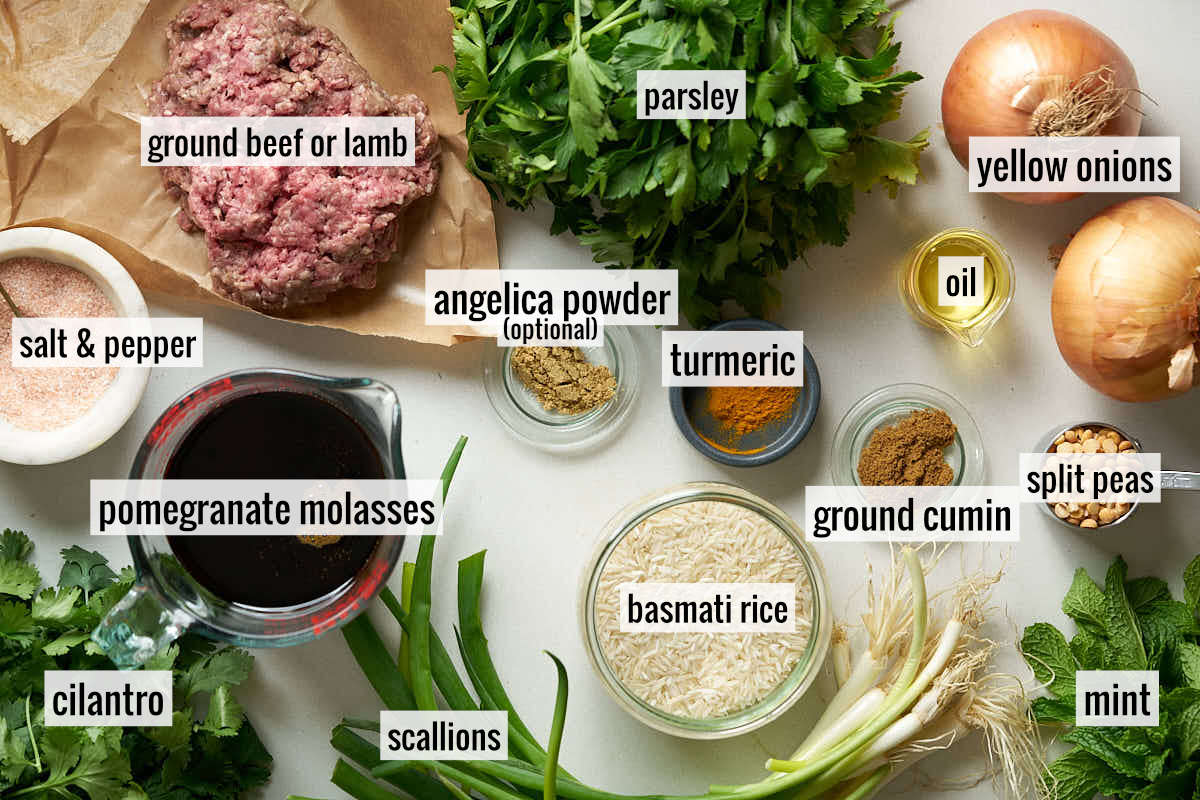 Ingredients including beef, parsley, onion, and rice laid out on a flat marble surface with text labels.