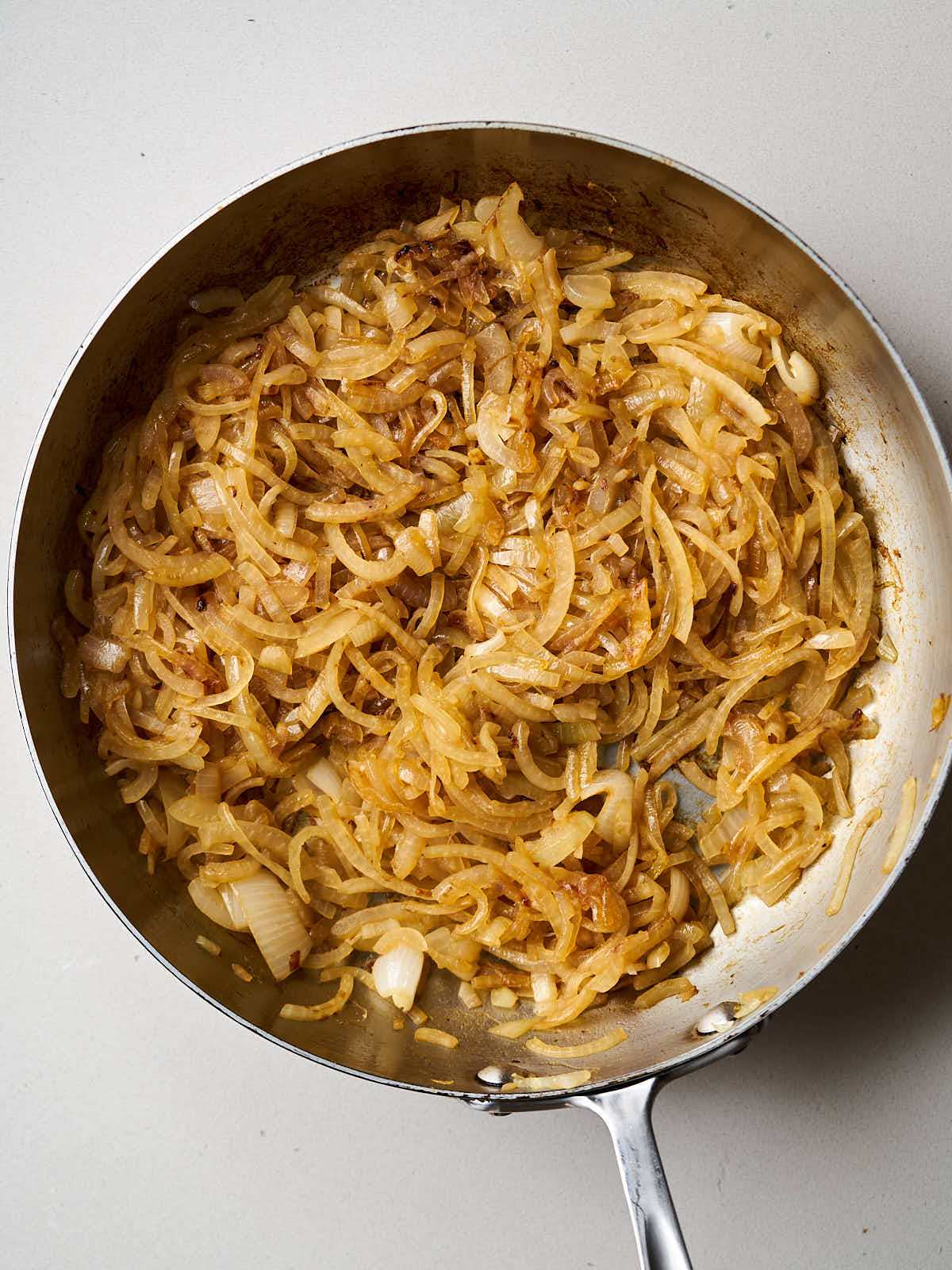 Caramelized onions in a metal fry pan.