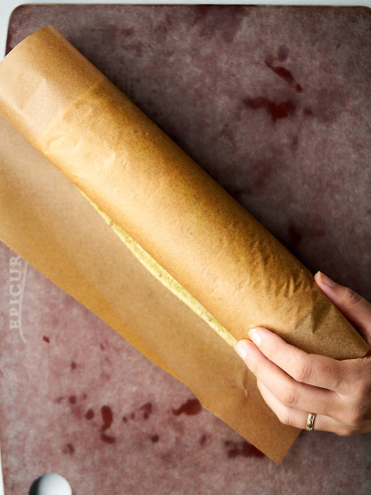 Thin cake rolled in brown parchment paper.