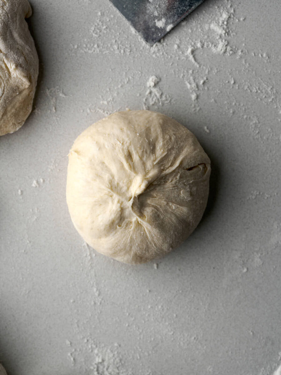 Pinched ball of dough on a countertop.