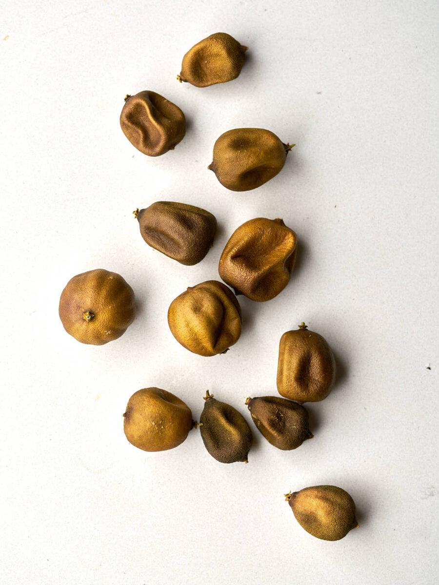 Whole dried limes on a countertop.