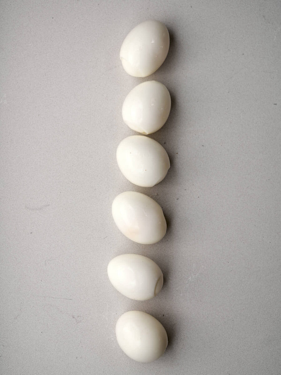 Six peeled boiled eggs.