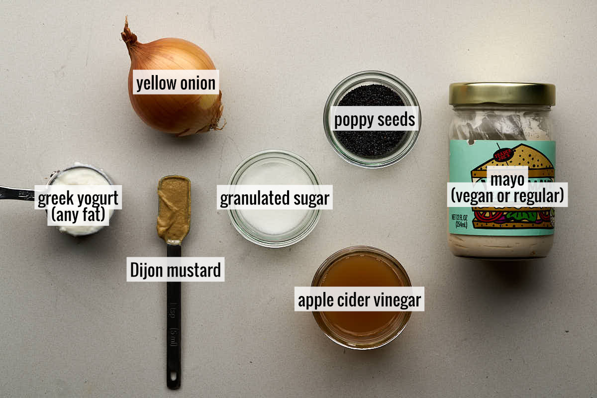 Labeled ingredients on a countertop to make poppy seed dressing.