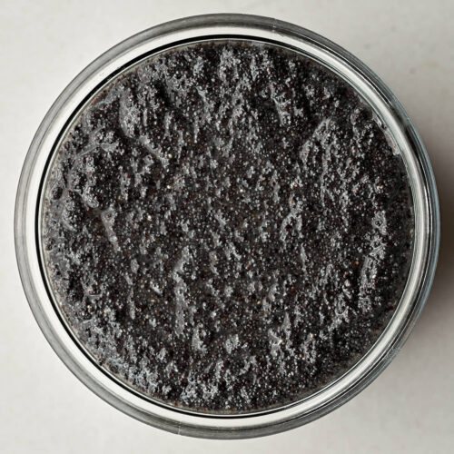 Top view of poppyseed filling in a glass jar.