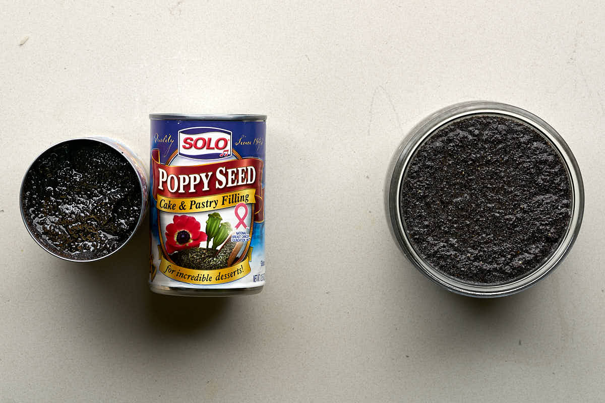 Two cans of poppyseed filling next to a jar of homemade poppyseed filling.