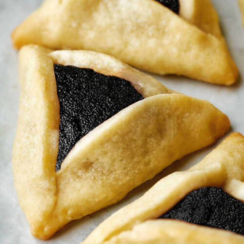 Triangular cookies with black poppyseed filling.